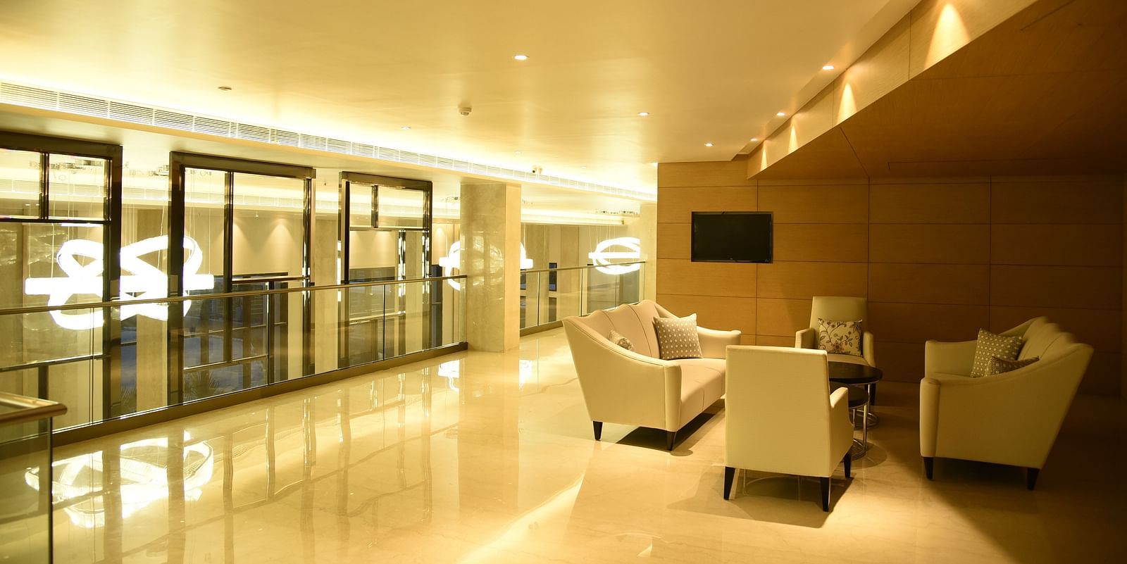 A lounge area featuring large cushioned furniture thoughtfully arranged around the table
