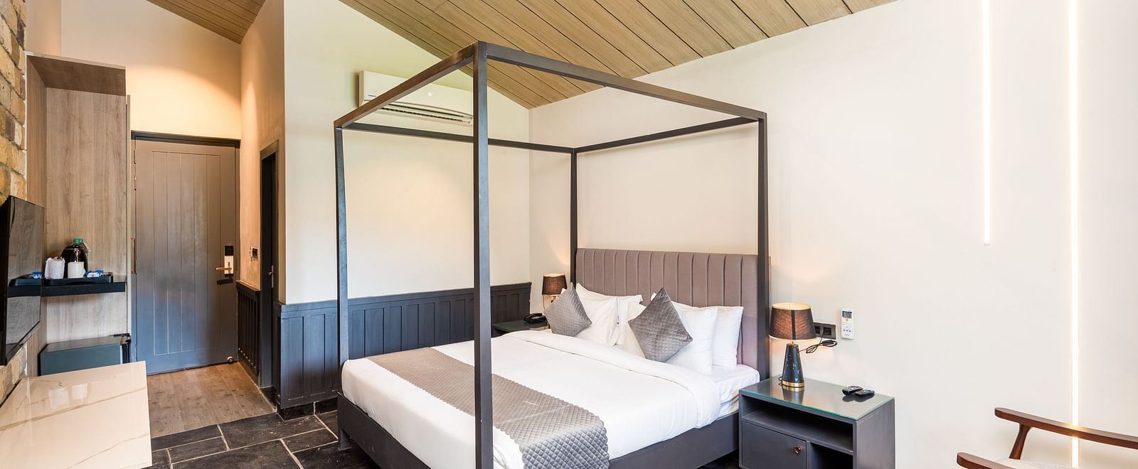 Overview of Luxury Cottage at DLS Divine River Resort and  Spa featuring a  king bed, table, chair and wardrobe.