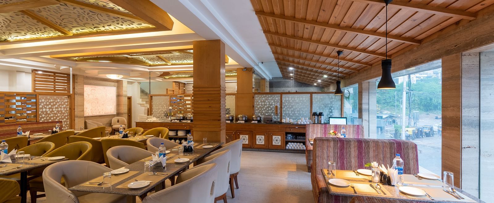 Restaurant at DLS Spring Valley Resort Dharamshala  with seating arrangement and ambient lighting 