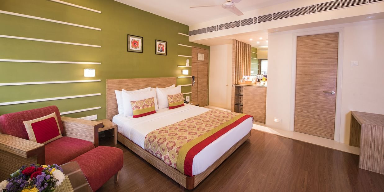 room with green interiors and wooden flooring - hotel bawa suites