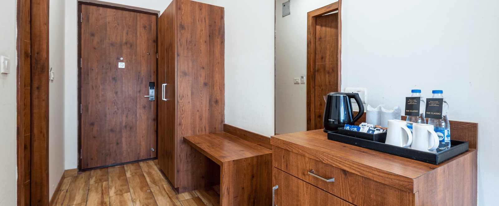 premium room with tea & coffee maker and a wooden wardrobe at DLS The Classio