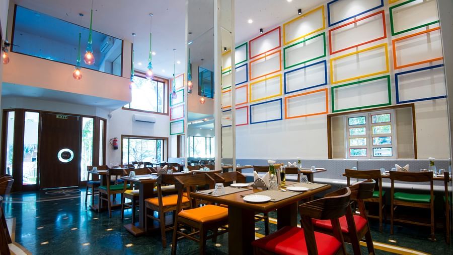 seatings arrangements inside the restaurant with plates kept on the table - VITS Sharanam, Thane