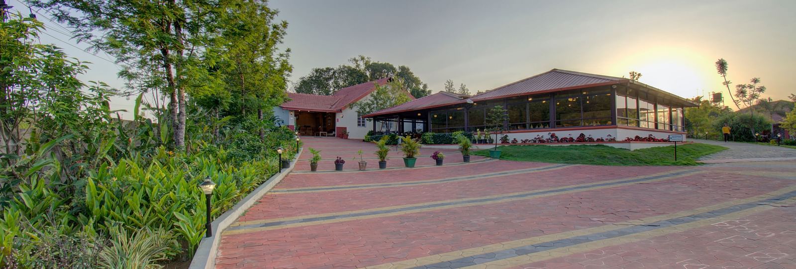Tiled floor with a house , sunset and greenery | Woodstock Resorts, Coorg