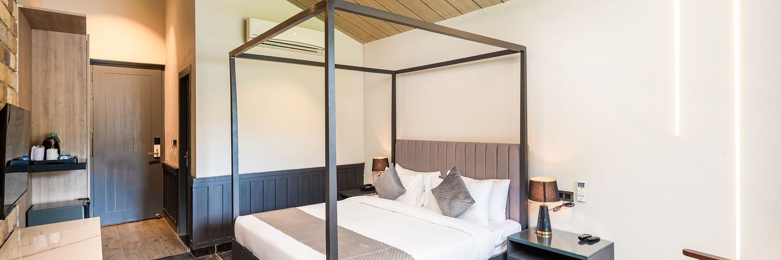 Overview of Luxury Cottage at DLS Divine River Resort and  Spa featuring a  king bed, table, chair and wardrobe.