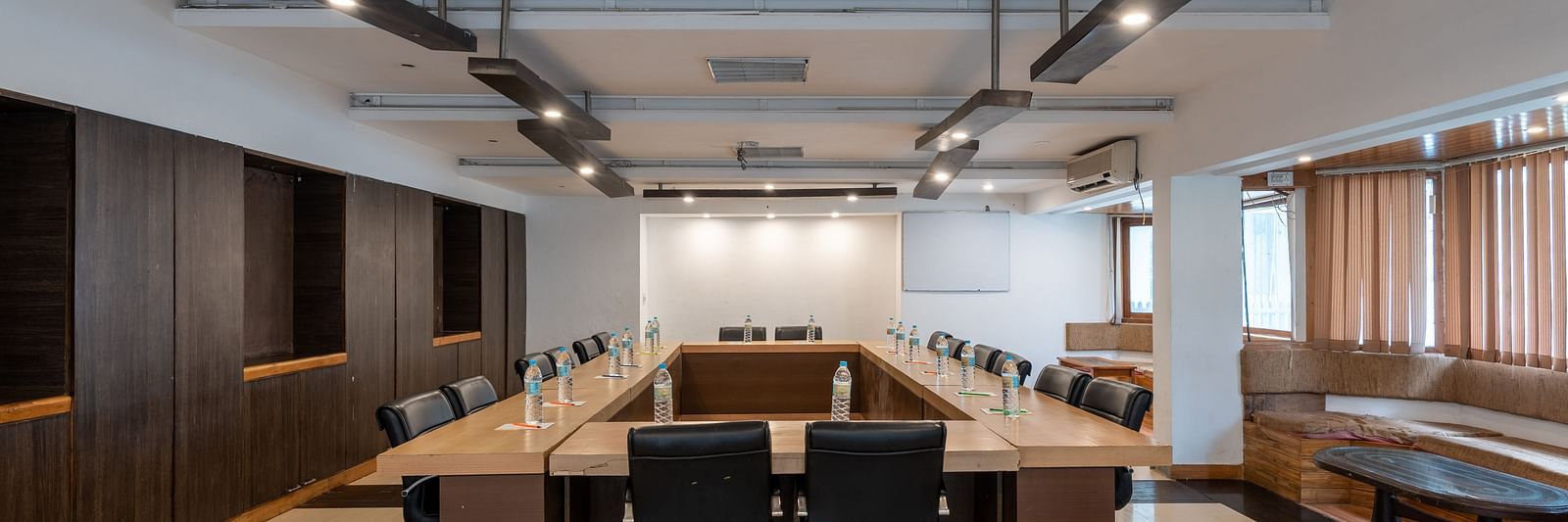 Conference Hall  at DLS Spring Valley Resort Dharamshala  with chairs and tables arranged in boardroom setting 