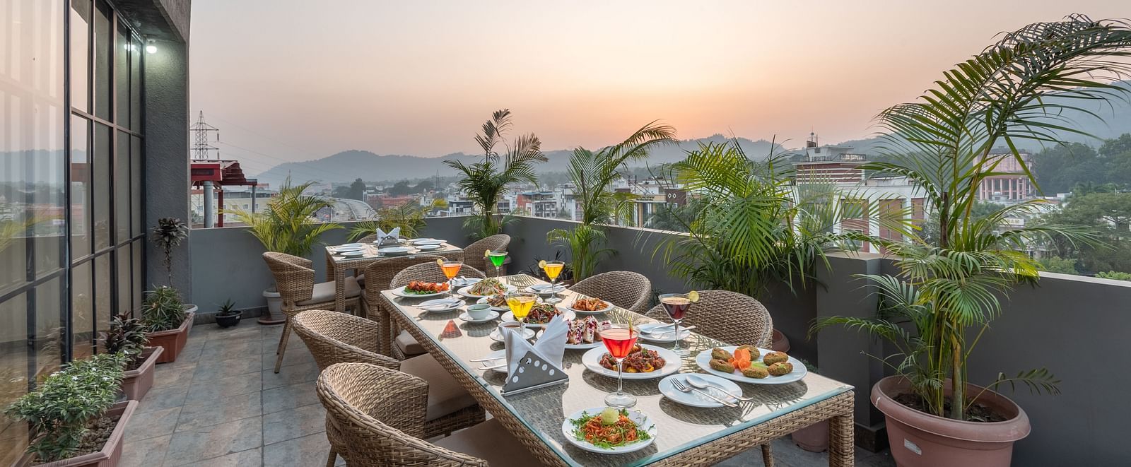 The roof top dining at DLS Hotel Arihant, Haridwar with chairs and tables overlooking the view