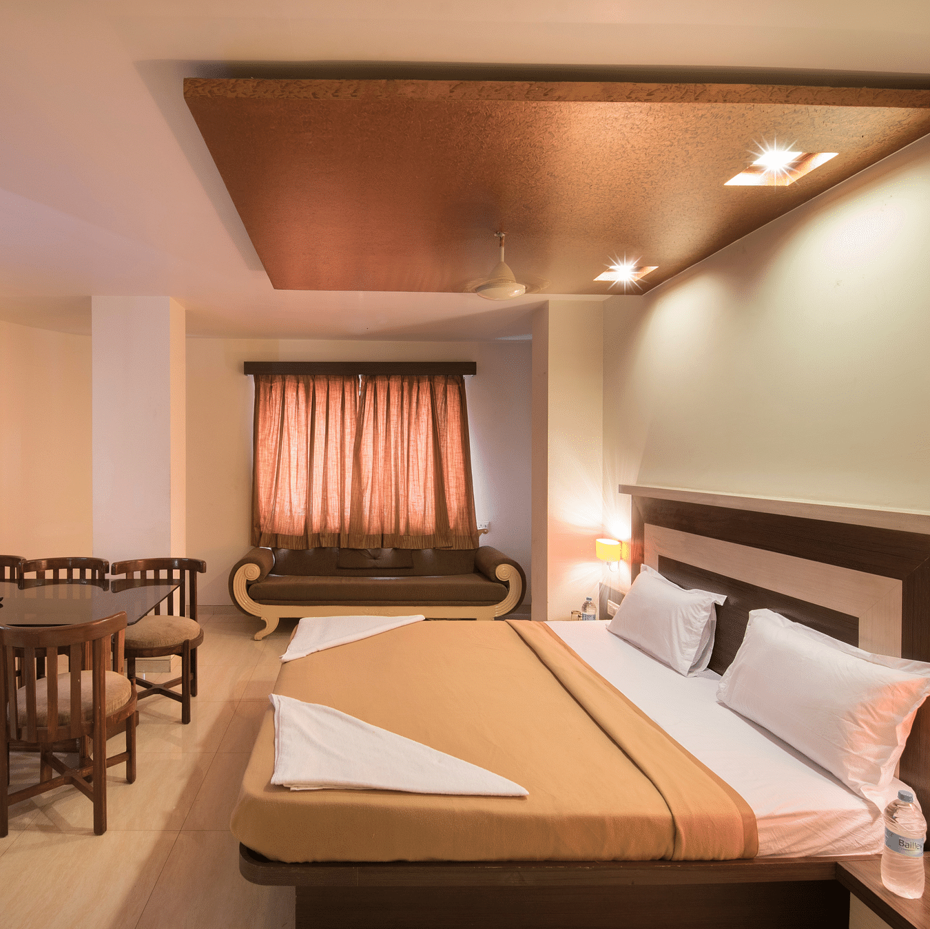 The bedroom offering a bed and a sitting space at the royal suite at Vaikunth by Adamo