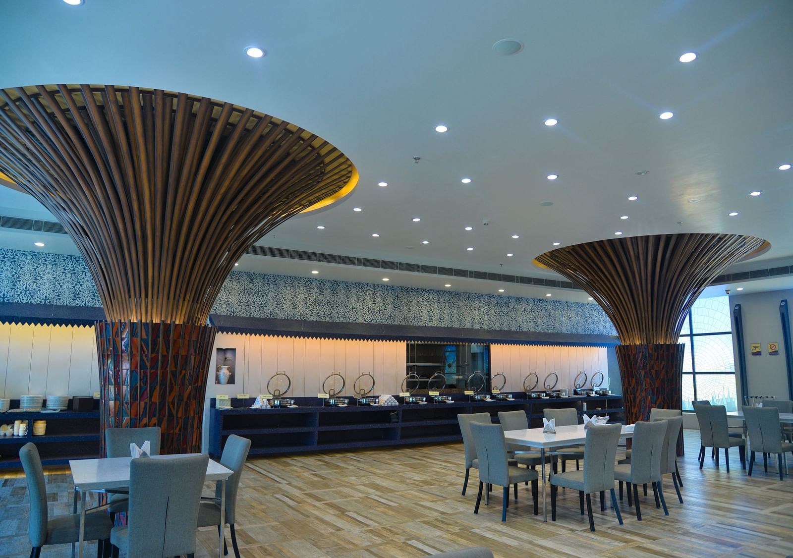 A restaurant with several tables and sofa chairs - Golden Blossom Imperial Resorts, Lucknow