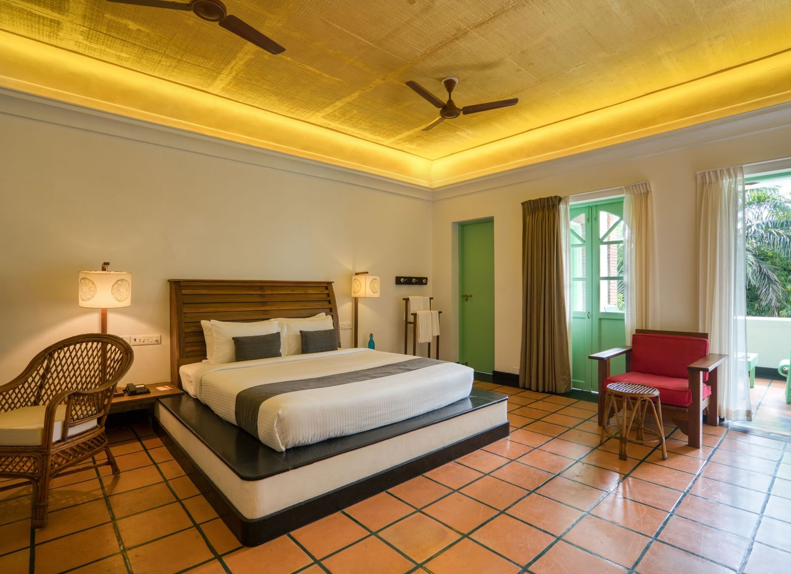 French Classic Bedroom at Mango Hill Auroville, Pondicherry featuring a plush bed in warm lighting as the daylight lights up the room