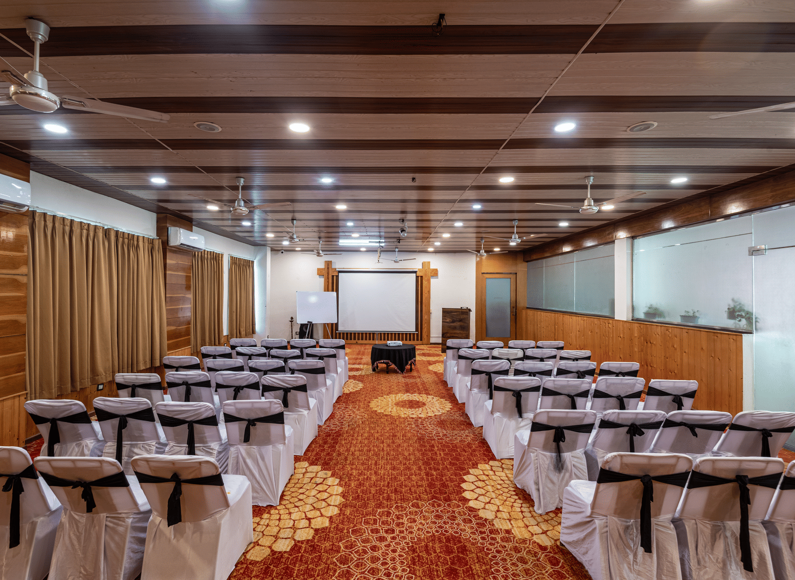 Rows of chairs aligned in a meeting hall at DLS Hotels On The Ganges.