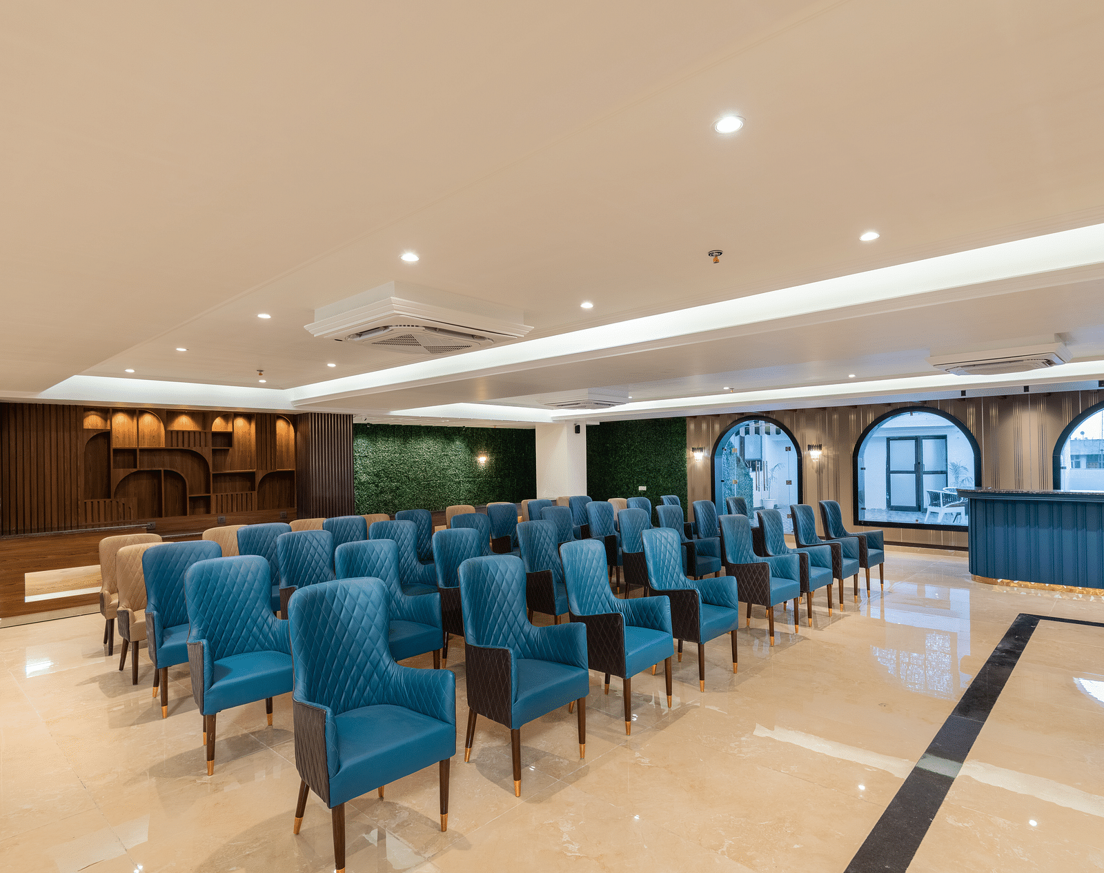 A shot of the banquet hall with chairs and huge windows on the right - DLS Grand Luxotica, Dehradun