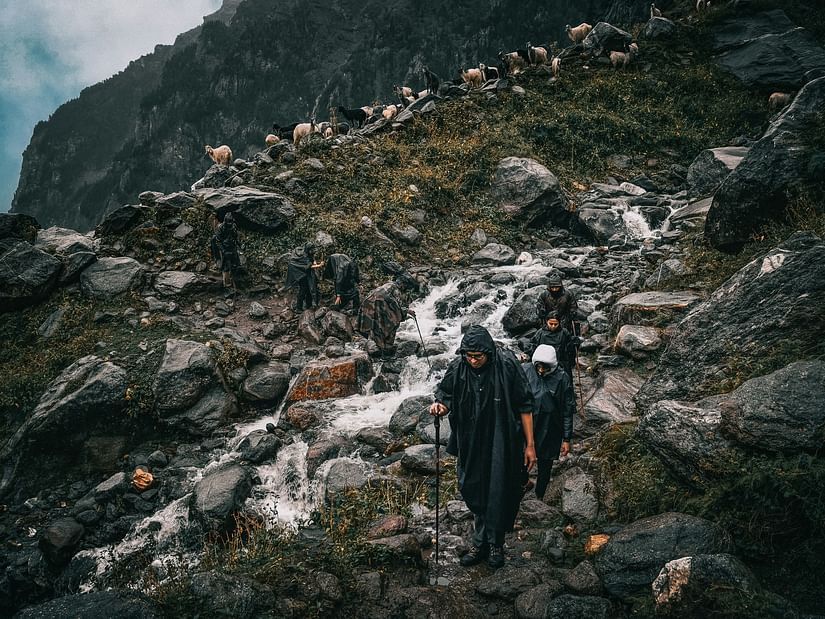 a group of trekkers climbing on a Hampta Pass trek with rocky terrain in view