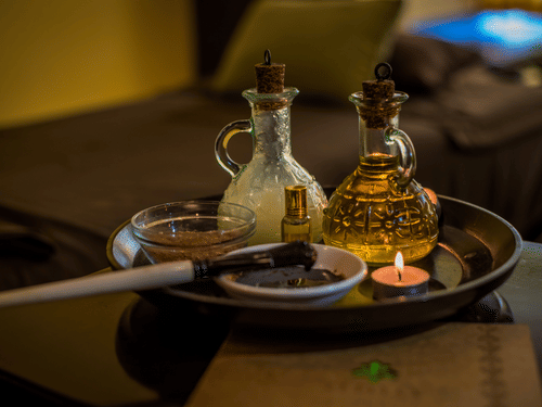 A close up of the essential oils kept on the table for a massage session at Oma Spa at The Serai Chikmagalur.
