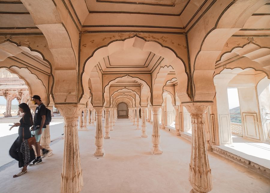 a couple roaming around an arch-shaped temple ground