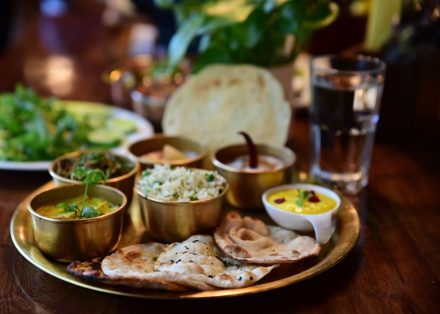 closeup-shot-indian-tasty-food-called-marwari-veg-thali-wooden-table