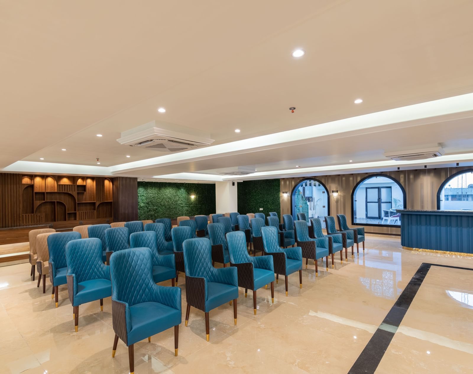 An overview of the banquet hall with chairs and huge windows on the right - DLS Grand Luxotica, Dehradun.