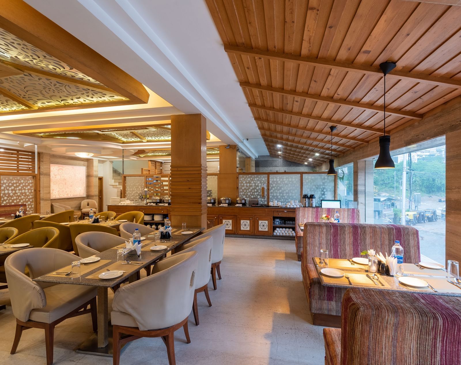 Restaurant at DLS Spring Valley Resort Dharamshala  with seating arrangement and ambient lighting 