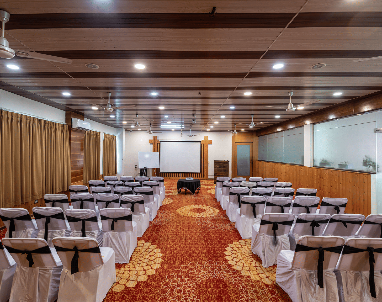 Rows of chairs aligned in a meeting hall at DLS Hotels On The Ganges.