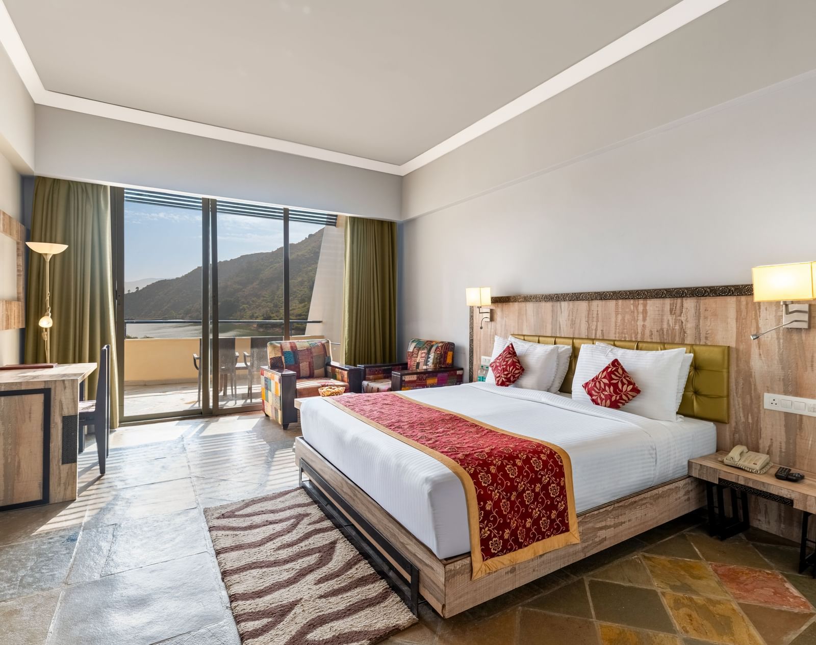 A wide angle shot of a bed with a runner on it and a large window - Via Lakhela Resort & Spa
