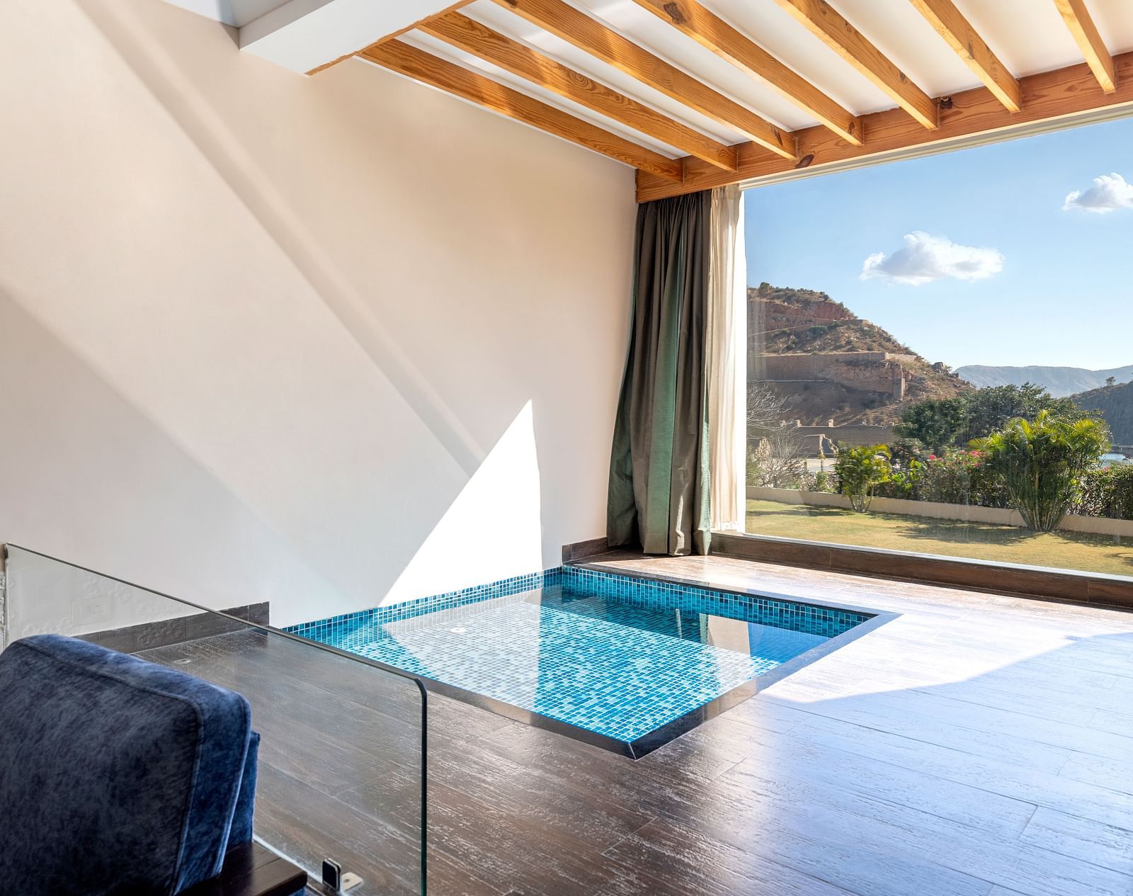 A private plunge pool on a balcony with mountains visible through open wall - Via Lakhela Resort & Spa