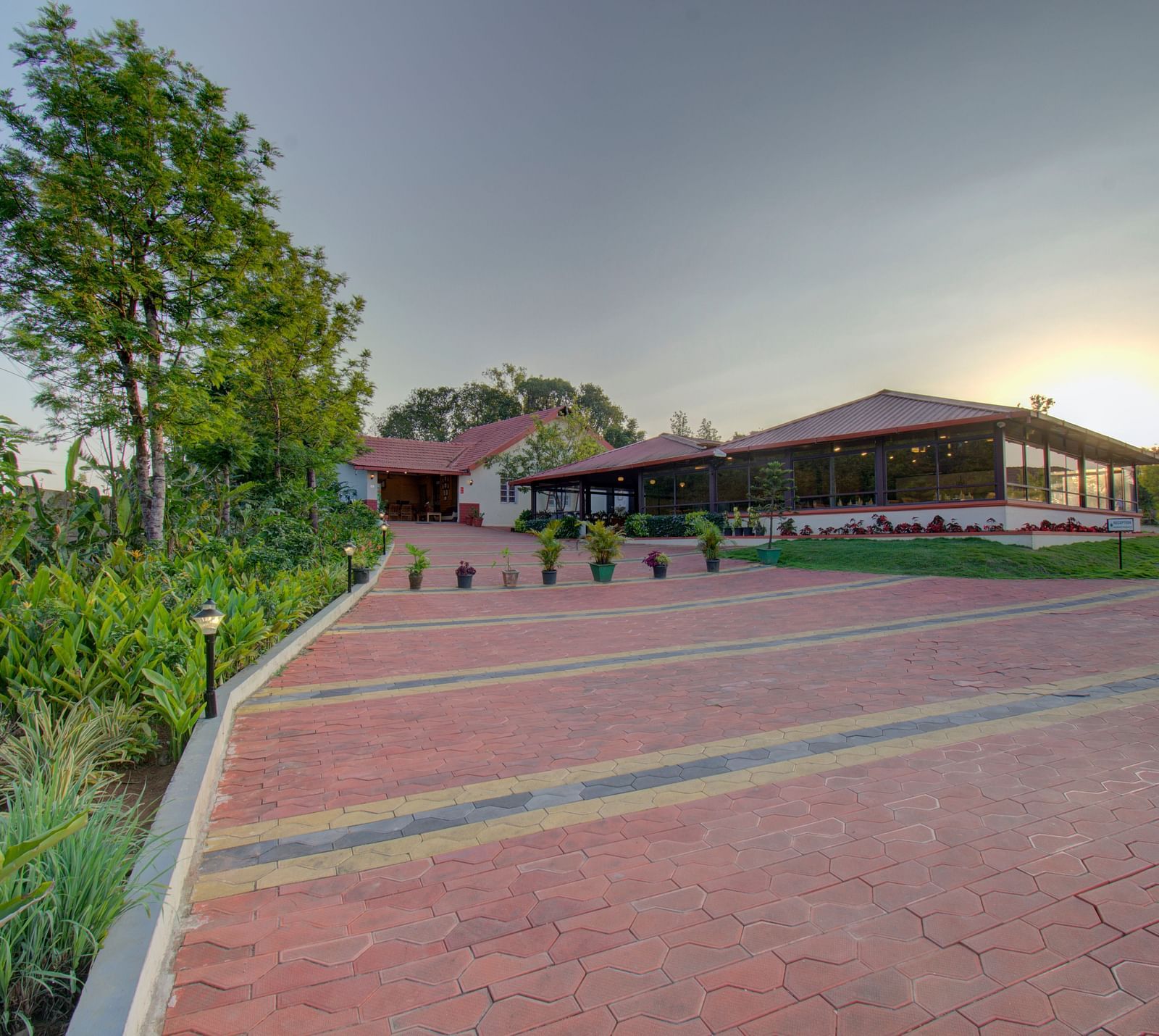 Tiled floor with a house , sunset and greenery | Woodstock Resorts, Coorg