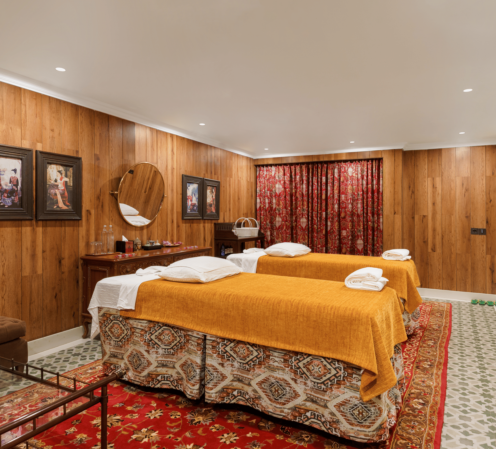 Luxury spa treatment room with massage beds and warm wood panelling at Mayfair Manor, Jungpana.