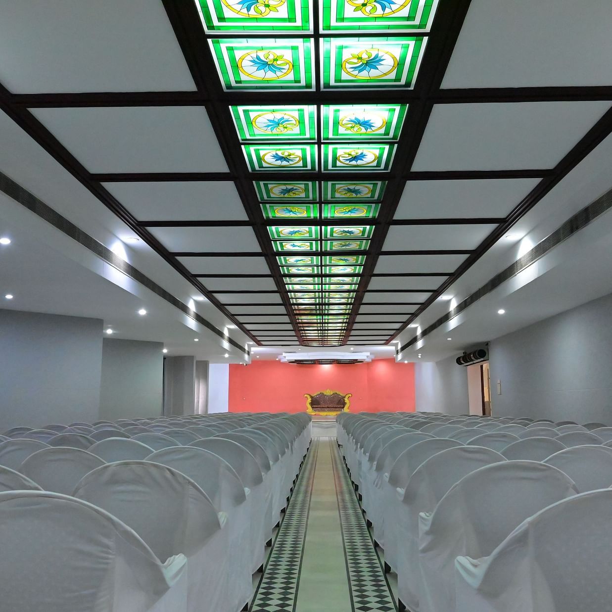 Back view of banquet hall with multiple chairs arranged for meetings and celebrations - Jayaram Hotel, Pondicherry