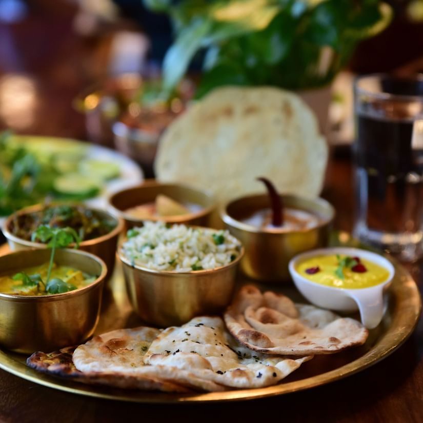 closeup-shot-indian-tasty-food-called-marwari-veg-thali-wooden-table