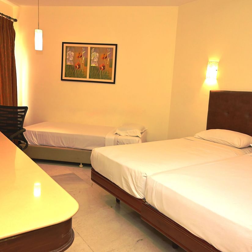 Side view of Suite with large bed, desk and other basic amenities - View of Standard Room for double occupancy with plush bed and basic amenities - Jayaram Hotel, Pondicherry
