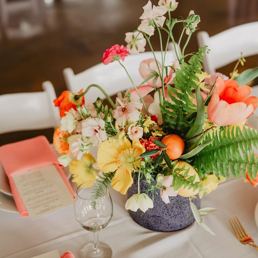 Elegantly designed flower bouquet kept on table along with cutlery 