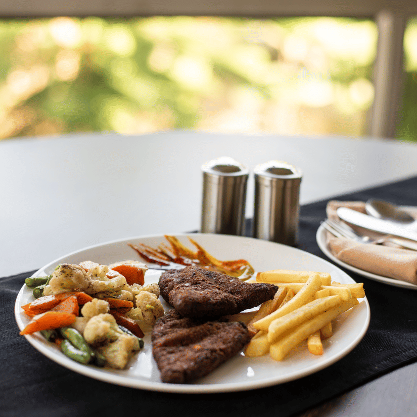 Food on a plate with a glass beside served at a restaurant in Polo Hotels, Tura.