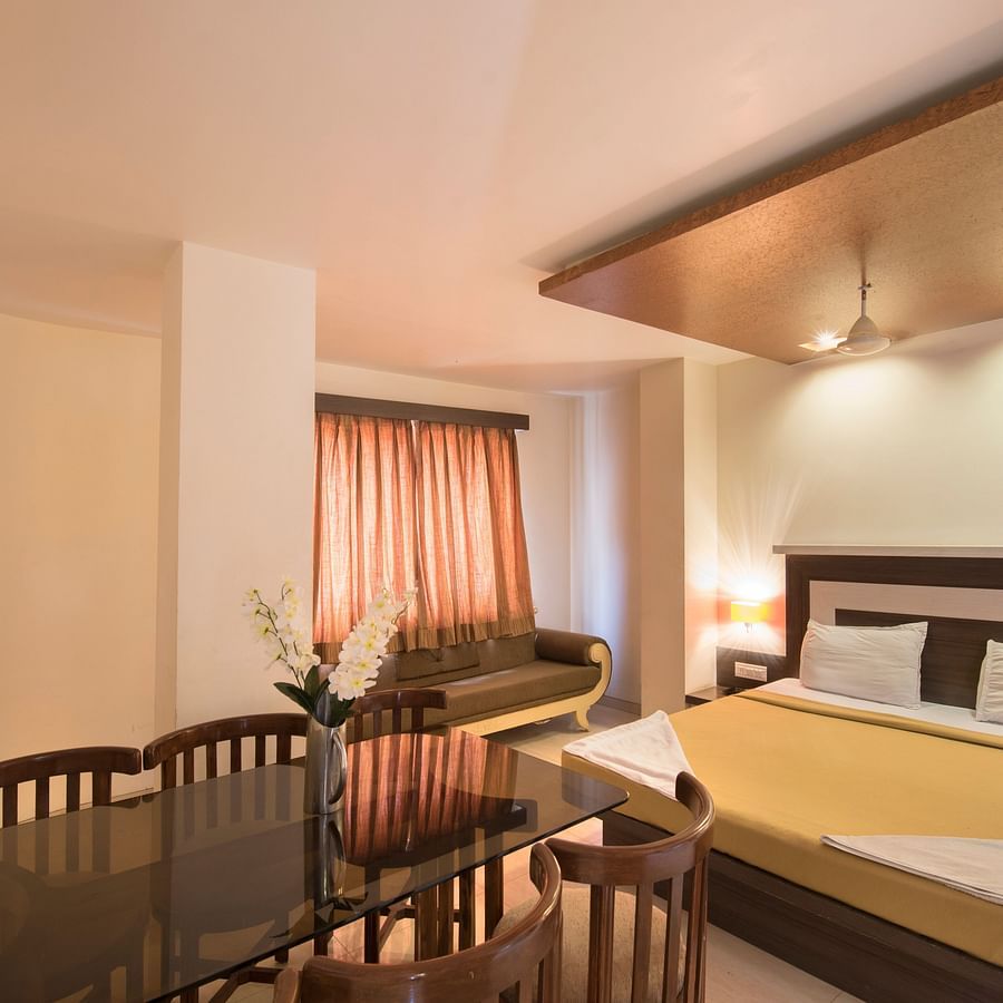 the bed and a sitting area offered at the Royal room in Nathdwara 1