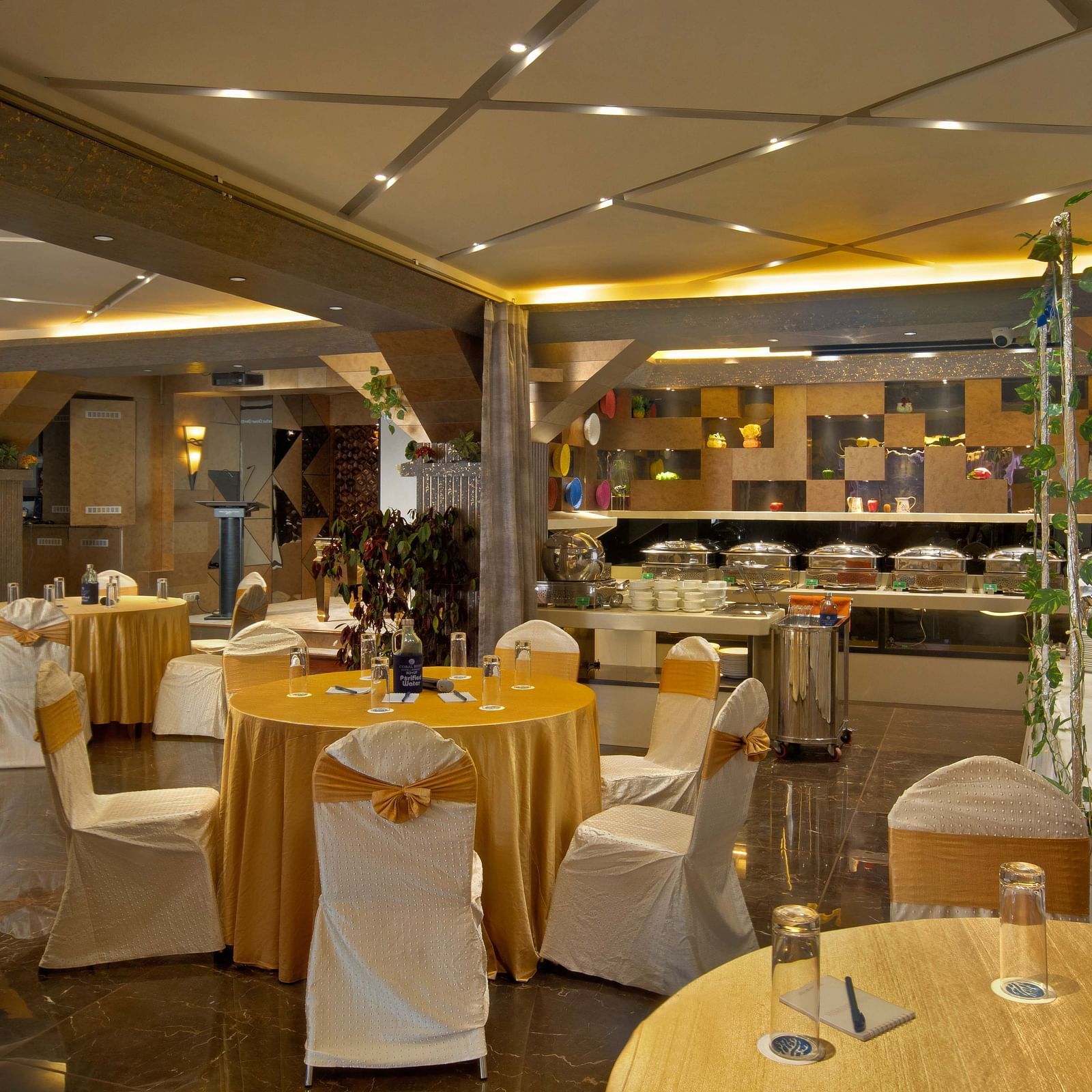 Image of tables and chairs arranged in circle at Mosaic Hall at Coral Reef Hotel and Spa in Port Blair