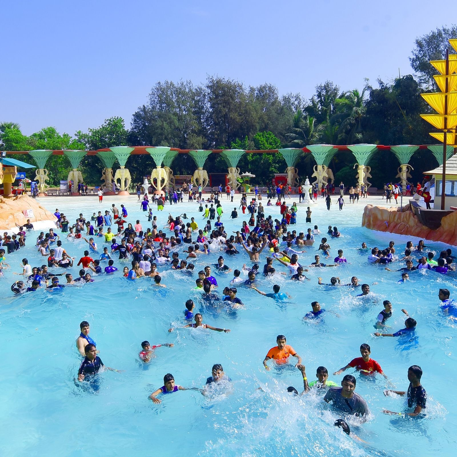 Water Kingdom - wide angle view of multiple people in a poop during daytime