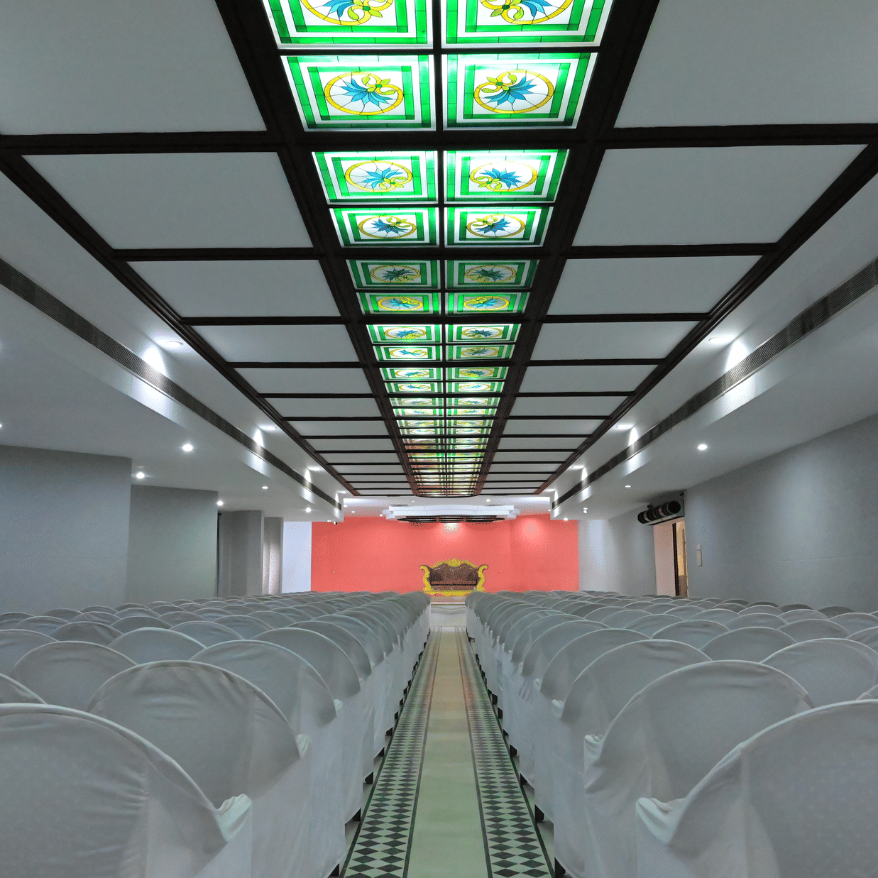 Back view of banquet hall with multiple chairs arranged for meetings and celebrations - Jayaram Hotel, Pondicherry