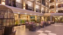 an open lobby featuring wicker dome seats, cosy seating arrangements, and ambient lighting - Golden Tulip, Candolim, Goa