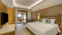 A king bed and tv inside Executive room at Shyama Sarovar Portico Orai