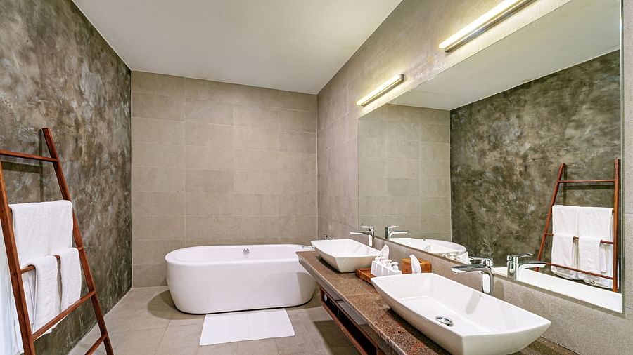 A side view of bathtub, mirror and sink in a bathroom | Celestial Hills, Kandy