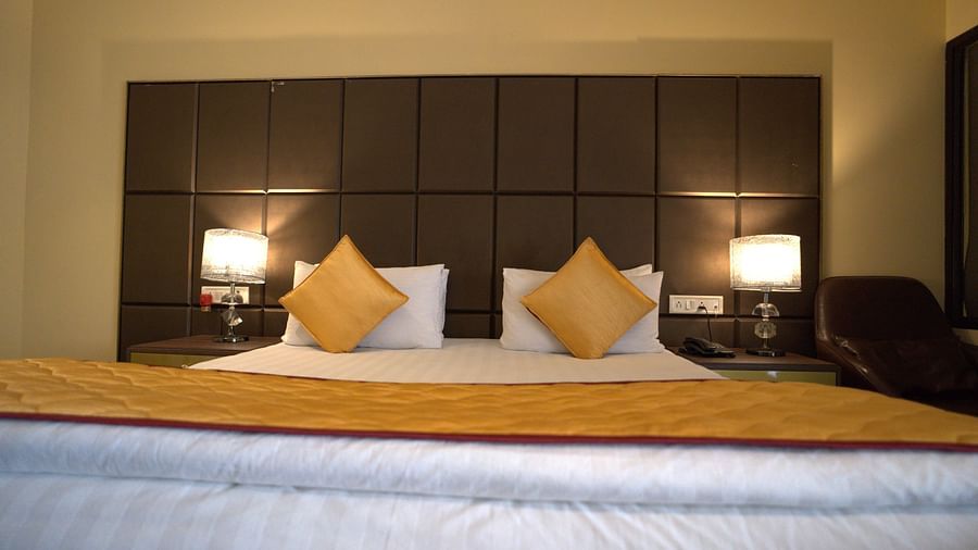 Deluxe Garden View Room at Citrus Classic Resorts and Spa Mahabalipuram ECR featuring a plush bed with fresh linen and pillows with cushions and duvet as well as a bed runner