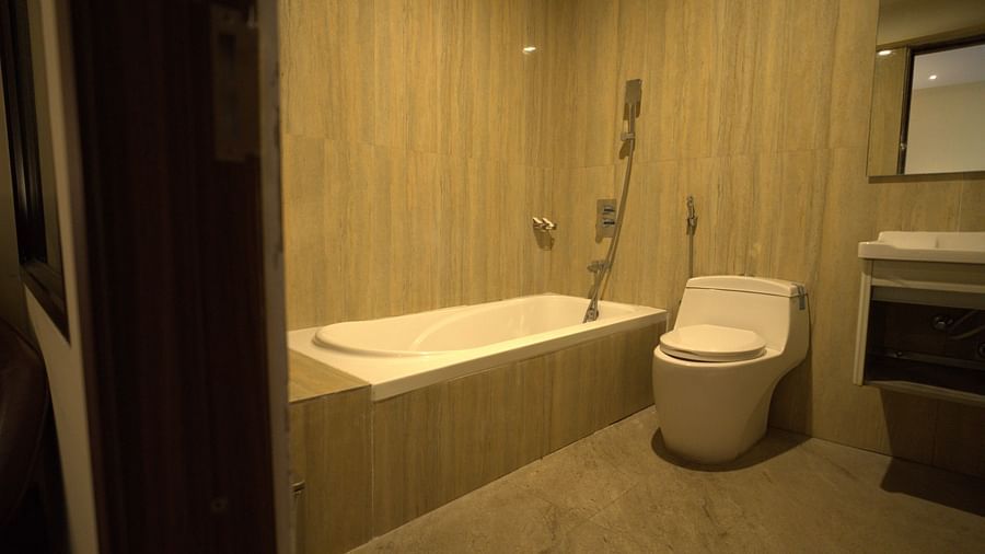 Washroom of Deluxe Garden View Room Citrus Classic Resorts and Spa Mahabalipuram ECR featuring a bathtub with a toilet next to it