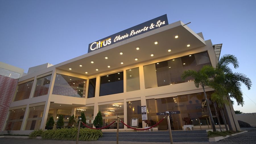 Facade of Citrus Classic Resorts and Spa Mahabalipuram ECR as the building is lit up with warm lights as the sun sets