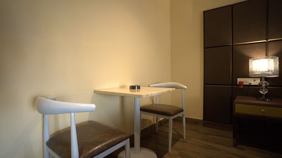 Junior Suite at Citrus Classic Resorts and Spa Mahabalipuram ECR featuring an indoor sitting space with a couple of chairs facing each other and a square coffee table in the middle