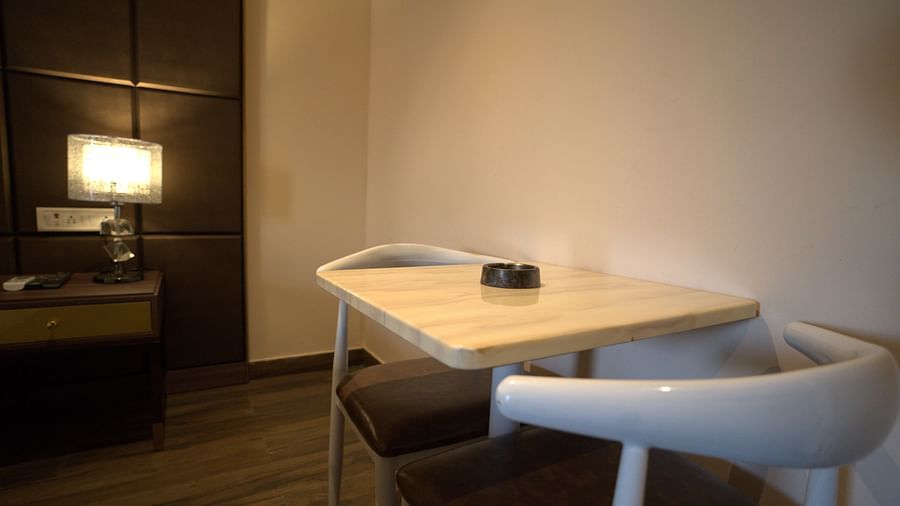 Sitting space in the room at Citrus Classic Resorts and Spa Mahabalipuram ECR featuring a couple of chairs and a coffee table with ashtray on it