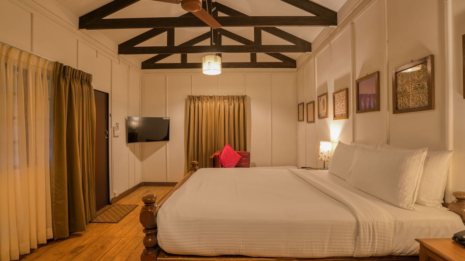 Swiss Chalet Bedroom with a bed, TV and paintings.