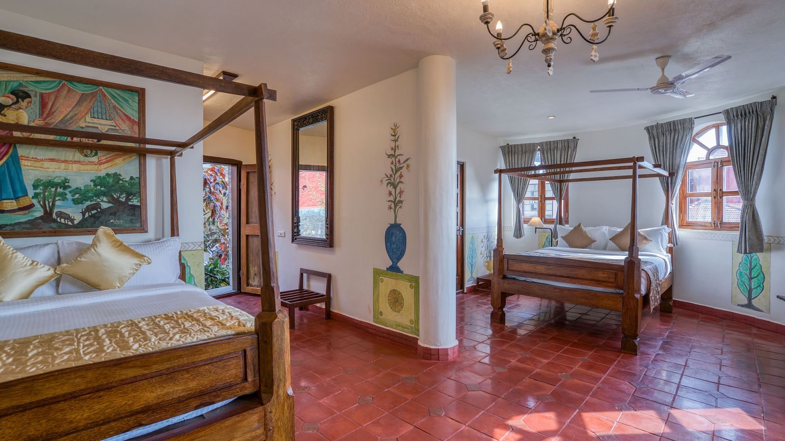 Spacious room with two four-poster beds, chandelier, and large windows providing natural light. | Mango Hill, Yercaud