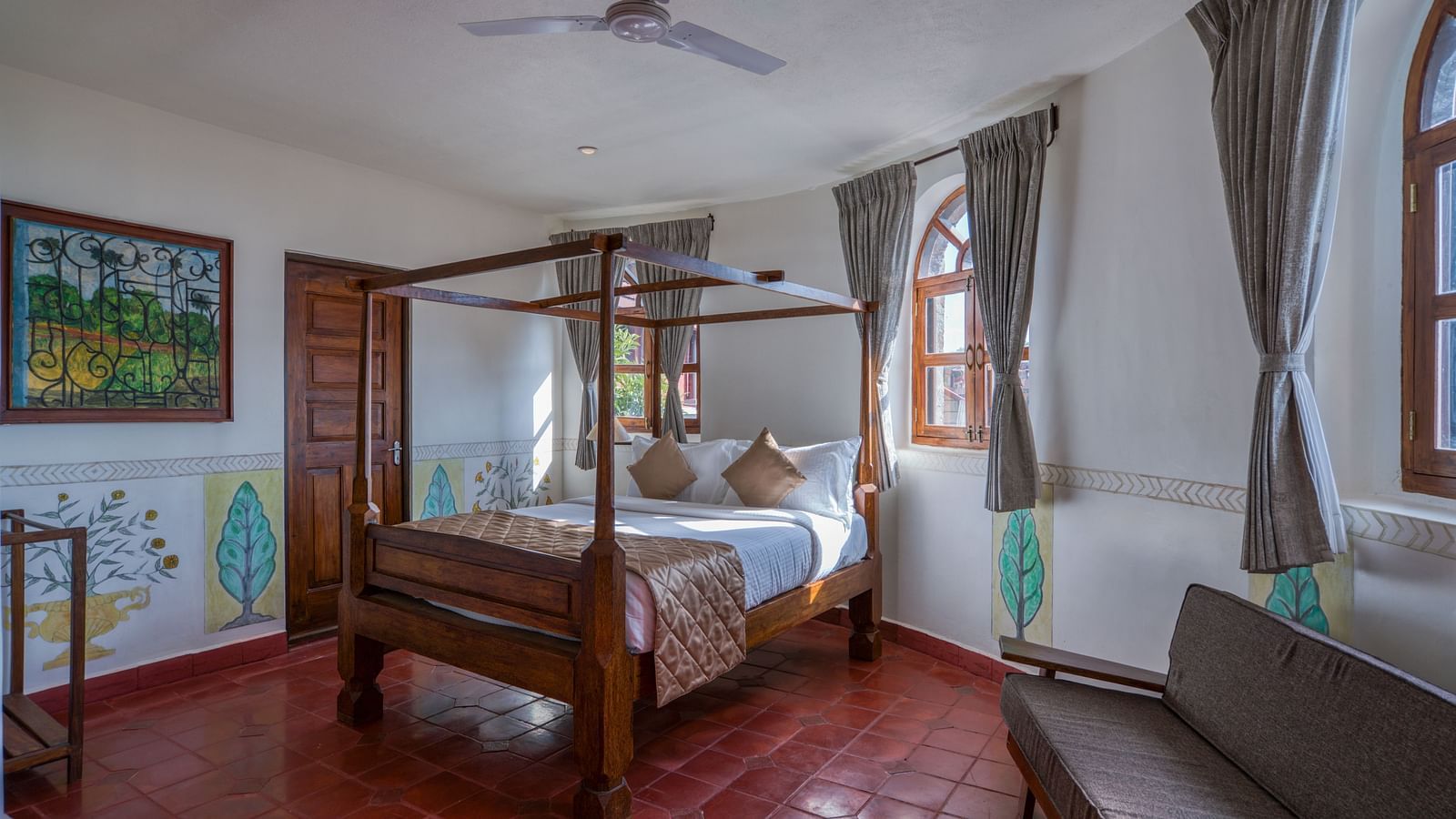 Hotel room with a four-poster bed, large windows, and rustic decor. | Mango Hill, Yercaud