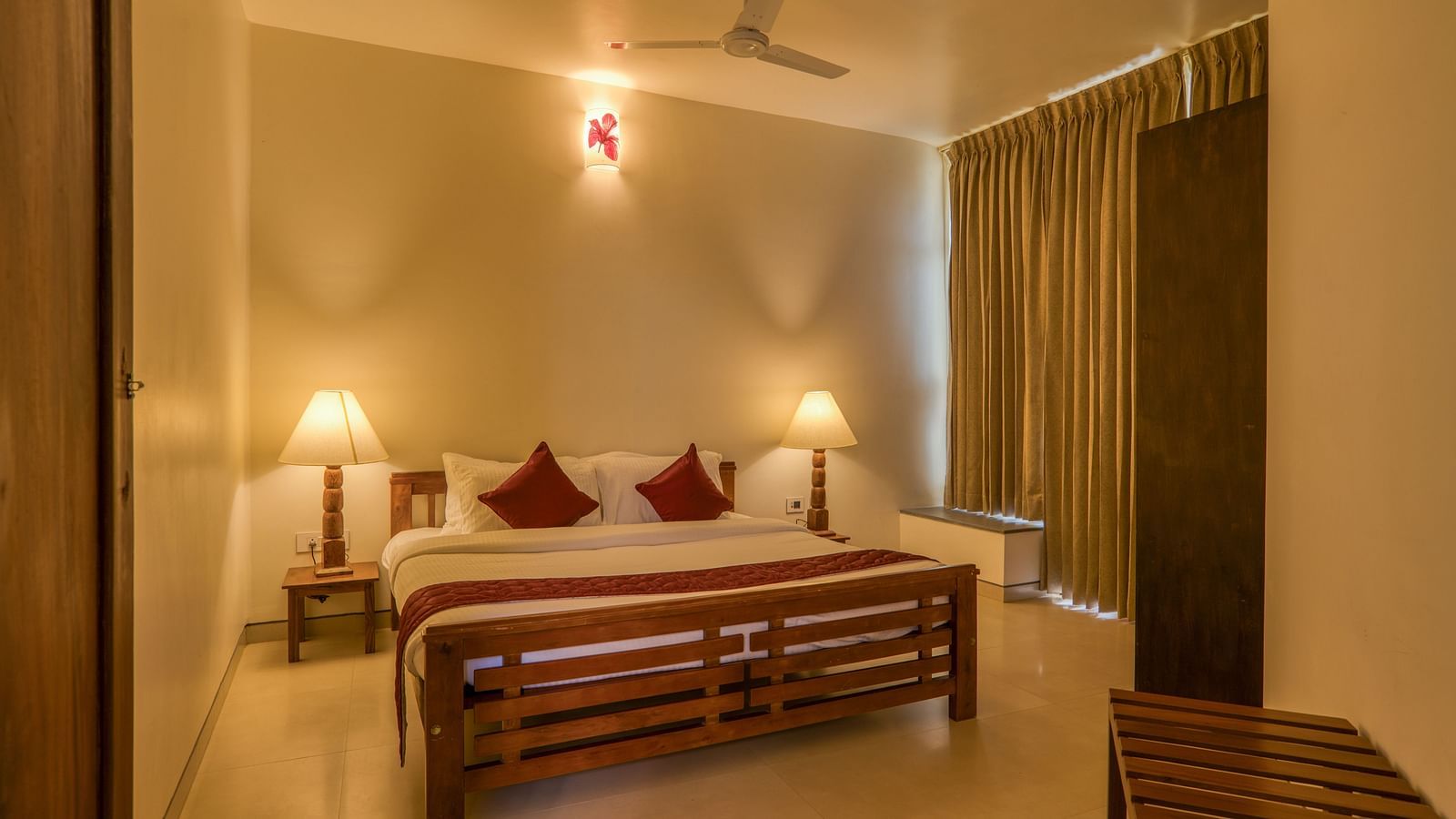 Cozy bedroom with a double bed, bedside lamps, and curtains  | Mango Hill, Yercaud