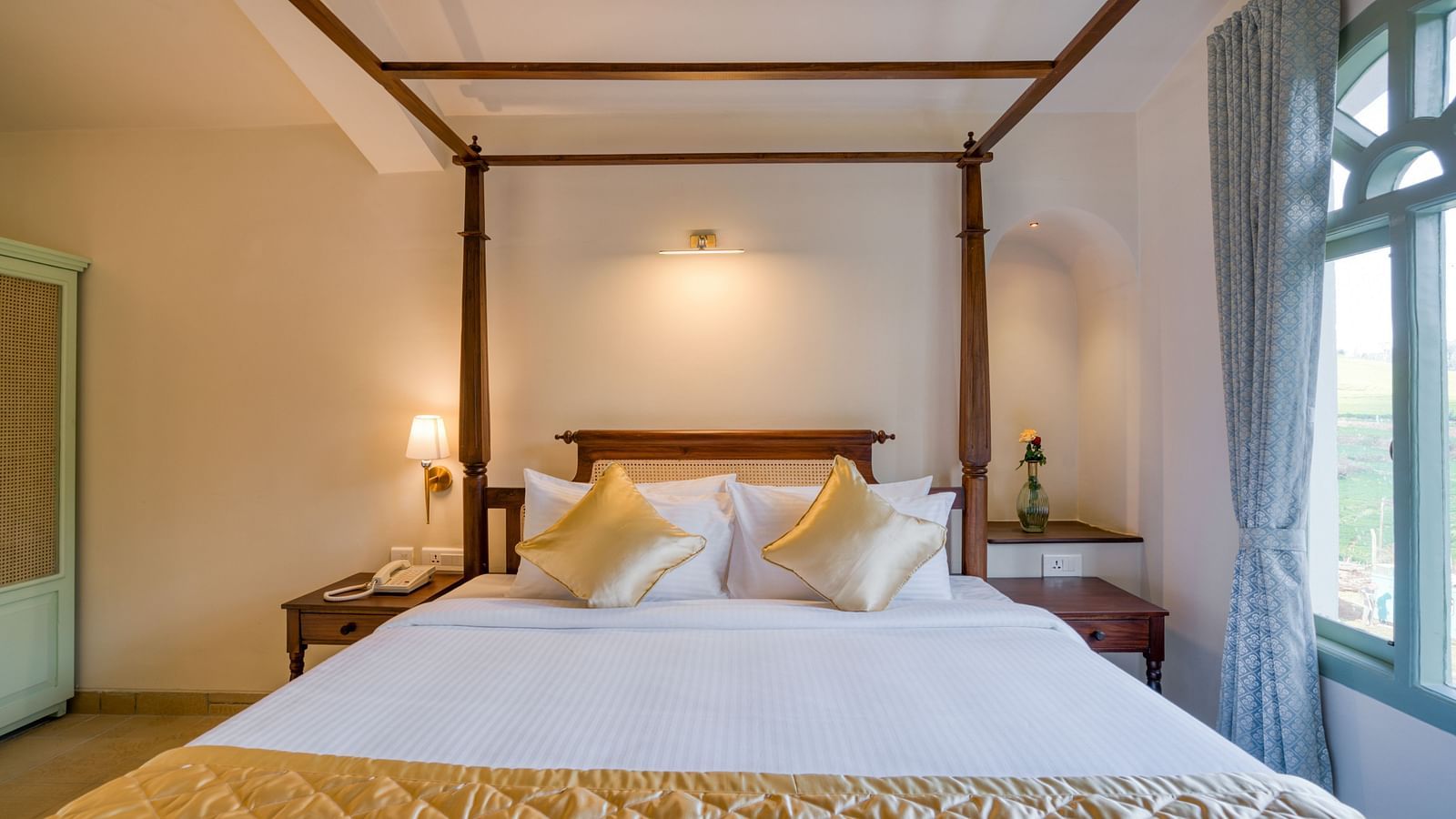 A close up shot of the double bed with golden runner and pillows | Mango Hill Shola Ooty