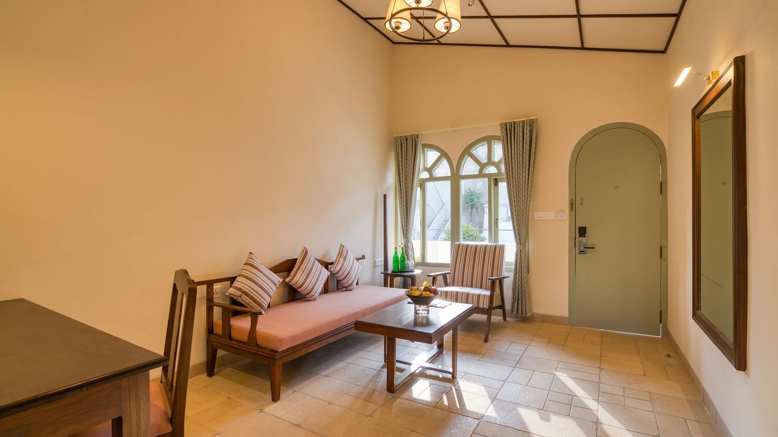 Overview of the living room with sofas inside deluxe room | Mango Hill Shola Ooty