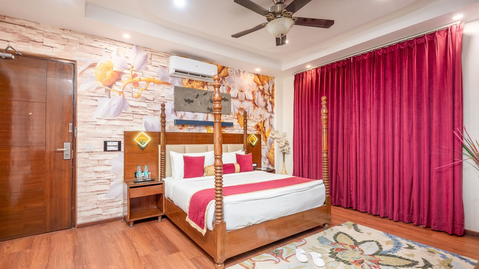 Double bed room with artistic wall décor at Regenta Inn DLS, Rishikesh.